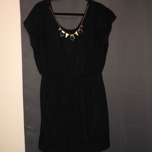 Black dress with gold necklace